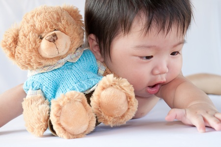 Little boy playing with a beer in whiteの写真素材