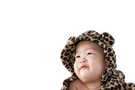 a beautiful smiling baby wrapped in a furry tiger skin