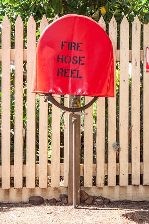 red fire hydrant reel near a wallの写真素材