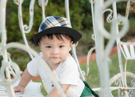 Thai boy with the hat in the parkの写真素材