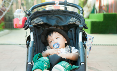 The boy in the stroller in the parkの写真素材