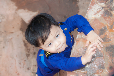 Thai boy in the pilot custome on the grassの写真素材