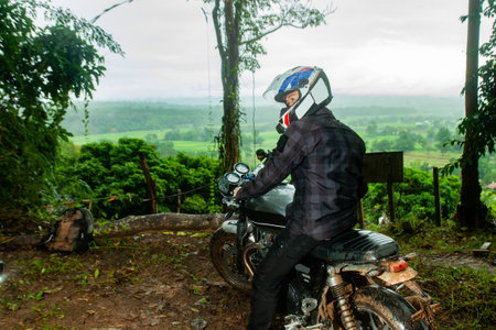 A man solo motorcycle trip in the forestの写真素材