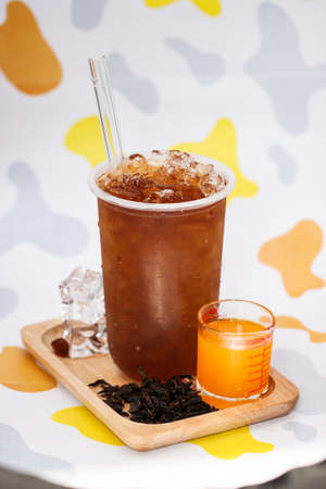 Lemon Thai tea with tea leaf in colorful backgroundの写真素材