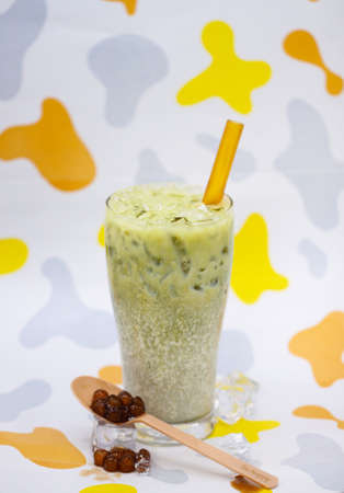 Lemon Thai tea with tea leaf in colorful backgroundの写真素材