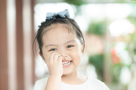 Asian little girl in the isolation with light yellow background