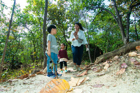 Thai family go into the wood, Thailandの写真素材