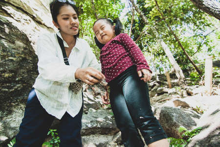 Daughter and mom go trekking in Thailandの写真素材