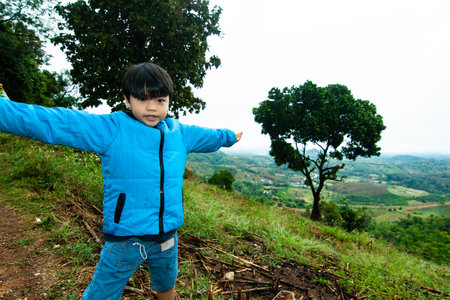 Thai boy in the feild. Chiang Rui, Thailandの写真素材