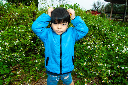 Thai boy in the feild. Chiang Rui, Thailandの写真素材