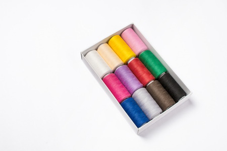 Colorful sewing threads on white backgroundの写真素材