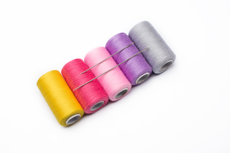 Colorful sewing threads on white backgroundの写真素材