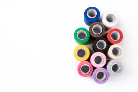 Colorful sewing threads on white backgroundの写真素材