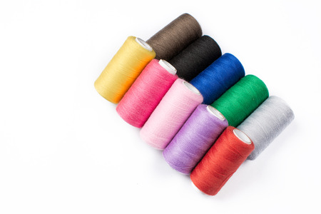 Colorful sewing threads on white backgroundの写真素材