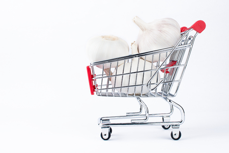 Garlic in a red shopping cartの写真素材