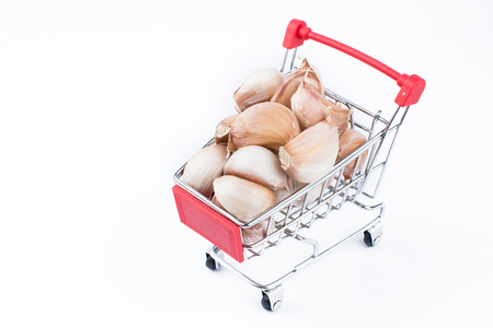 Garlic in a red shopping cartの写真素材