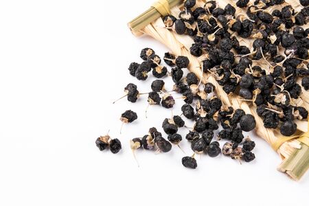 a basket of black cockroaches on a white backgroundの写真素材