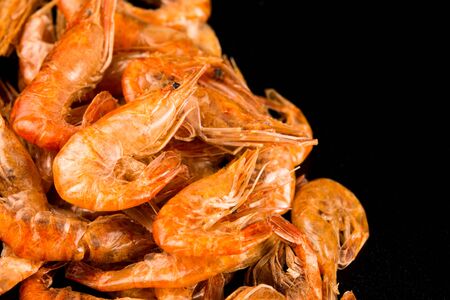 Dried river prawns close-up on a black backgroundの写真素材
