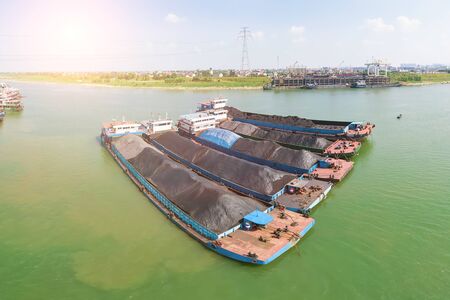 Aerial photography of a cargo ship parked on the river surface filled with coalの写真素材