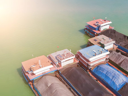 Aerial photography of a cargo ship parked on the river surface filled with coal