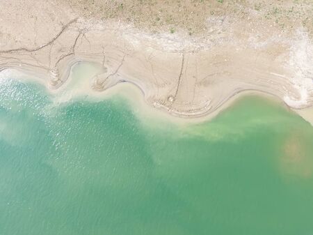 waterfront aerial picture, green river and  footprints of the river beachの写真素材