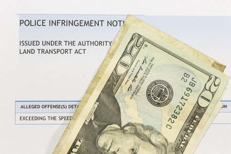 American paper currency on top of a police infringement notice.の写真素材