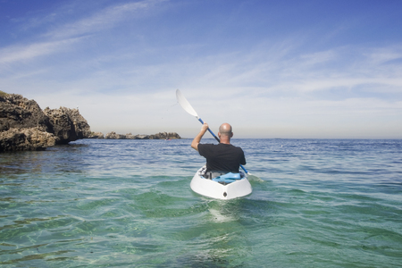 A guy kayaking around Seal island in Western Australia.の写真素材