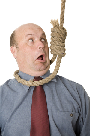 A businessman in noose, a cut backs, financial crisis concept.の写真素材
