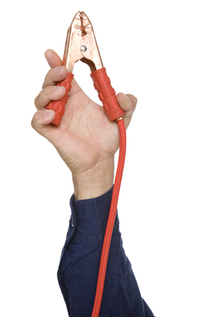A single hand holding a red Jumper cable.の写真素材