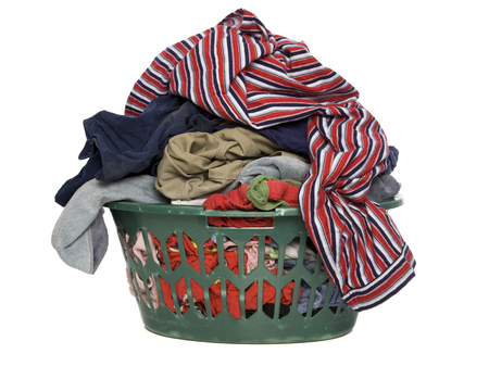 A basket full of dirty laundry on white.の写真素材