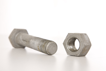 A large industial nut and bolt on a white background.の写真素材