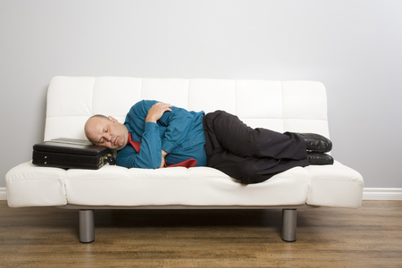 A man falls asleep waiting for appointment.の写真素材