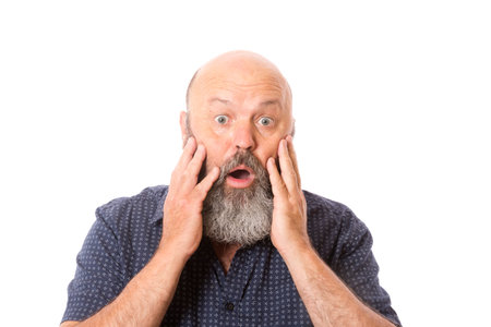 A man looking into camera with a shocked expression.