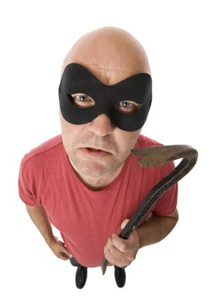 A robber with a tire lever, looking up at camera.の写真素材