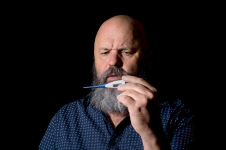 A man checking for a temperature with a worried expression.
