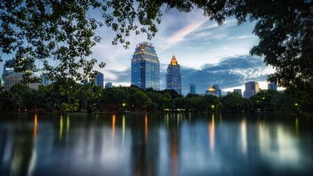 Bangkok, Thailand - Jun 8, 2016: Lumpini Park with Abdulrahim and U Chu Liang Buildings, Bangkok, Thailandのeditorial素材