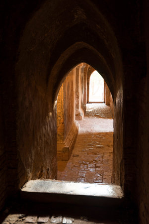 Inside of Dhammayangyi Pagoda illuminated by sunset, Bagan, Myanmarのeditorial素材