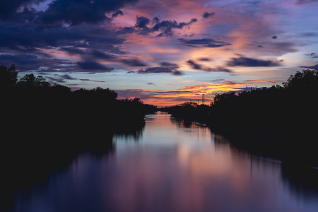 Colorful sky over a river in a countryの写真素材