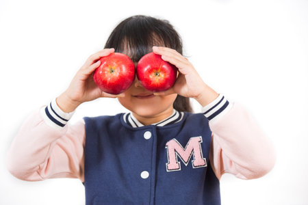 Asian Little girl with fruit and vegetables,concept Healthy food,  vitamin and diet  in the white background.の写真素材