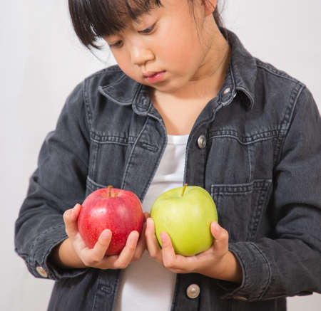 Asian Little girl with fruit and vegetables,concept Healthy food,  vitamin and diet  in the white background.の写真素材
