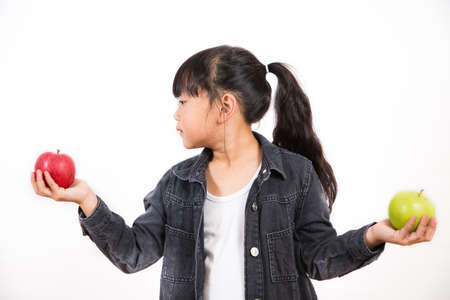 Asian Little girl with fruits and vegetables,concept Healthy food,  vitamin and diet  in the white background.の写真素材