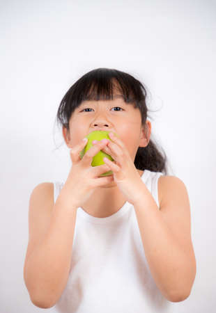 Asian Little girl with fruits and vegetables,concept Healthy food,  vitamin and diet  in the white background.の写真素材
