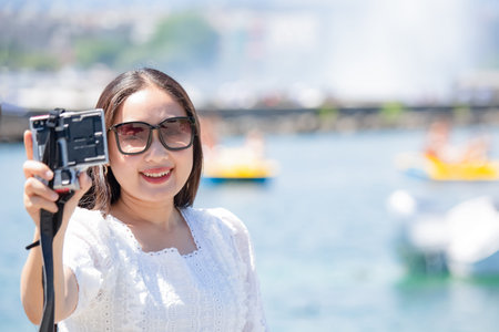 Asian beautiful woman is travel for holiday in the summer of Europe and taking a camera view...