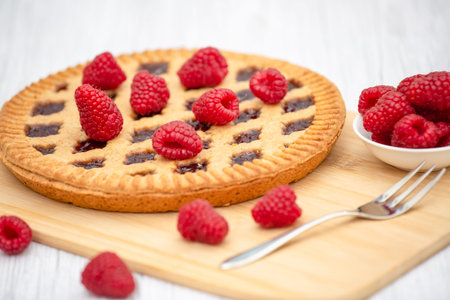 Dessert Raspberry Pie cake with strawberry or Fruit in a round bread for Break time or a party shot at the top view and copy space on a white wooden table.の写真素材
