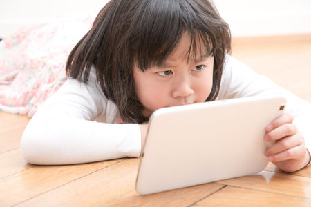 The young girl is watching the phone all day in the house or using a mobile phone for a long time...