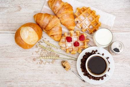 Breakfast in the morning with black coffee cup with bread with Croissant and fruit on the wooden...