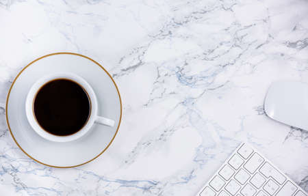 Black coffee on the desk with a computer, mouse Keyboard, book note, and pen Concept of working at home, personal businessの写真素材