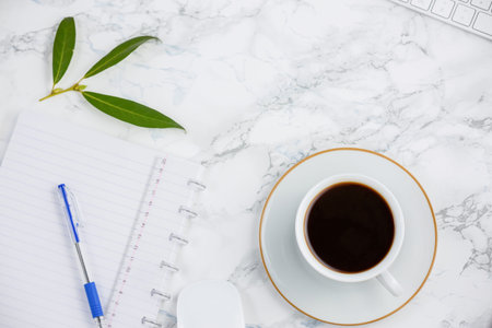 Black coffee on the desk with a computer, mouse Keyboard, book note, and pen Concept of working at...