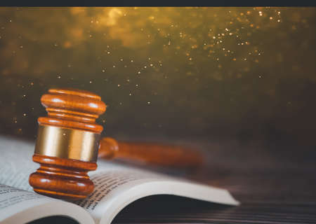 Old wood Judge hammer with law book on the table wood background, Used for adjudication and Justice.の写真素材