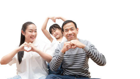 Happy family woman and a man with little child smiling and fun isolated over white backgroundの写真素材